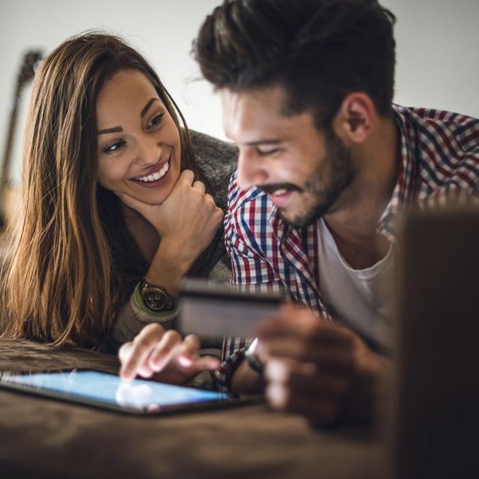 A couple manages their Patelco credit card on a tablet.